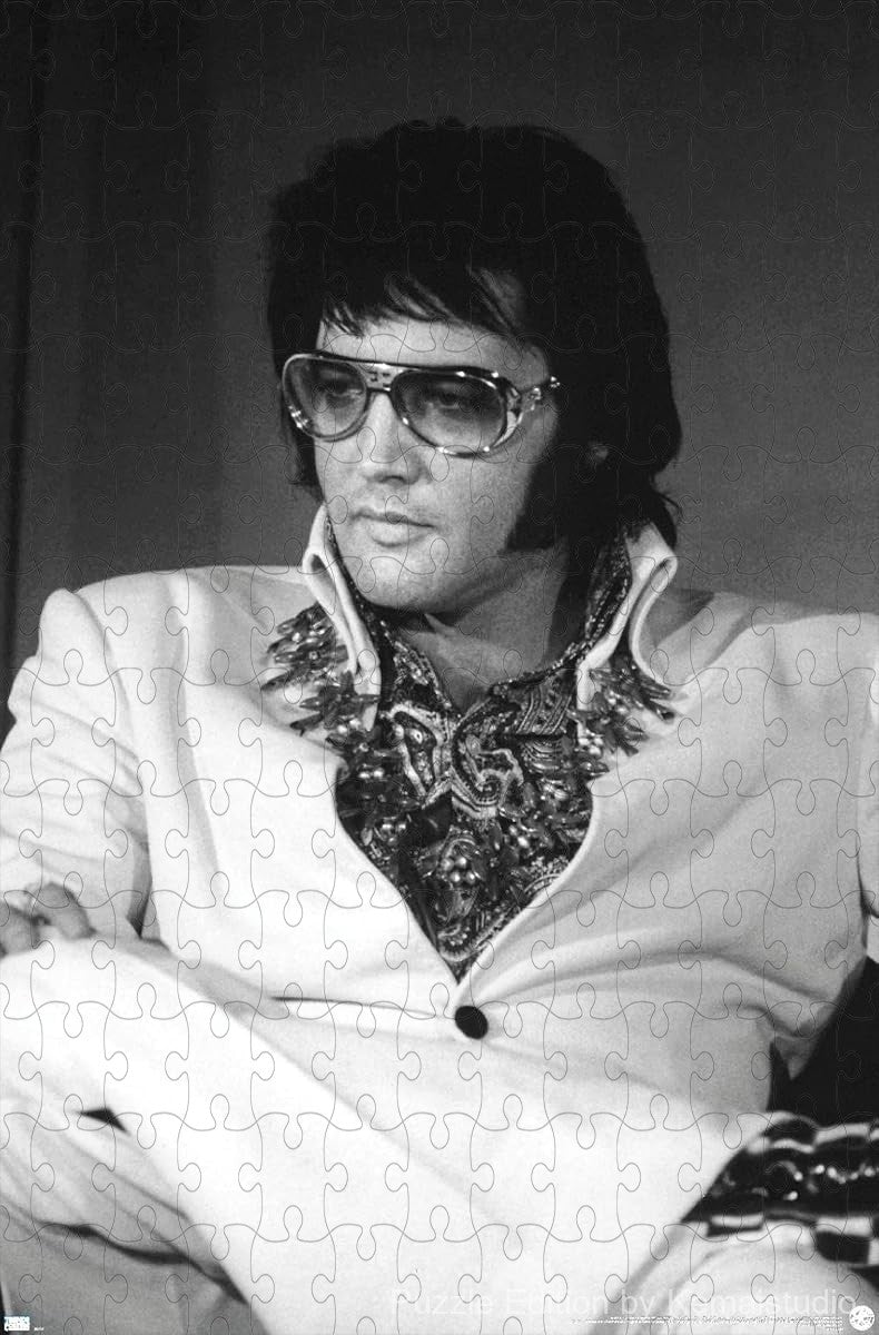 Elvis in a quiet moment, resting with his guitar in classic sepia tone