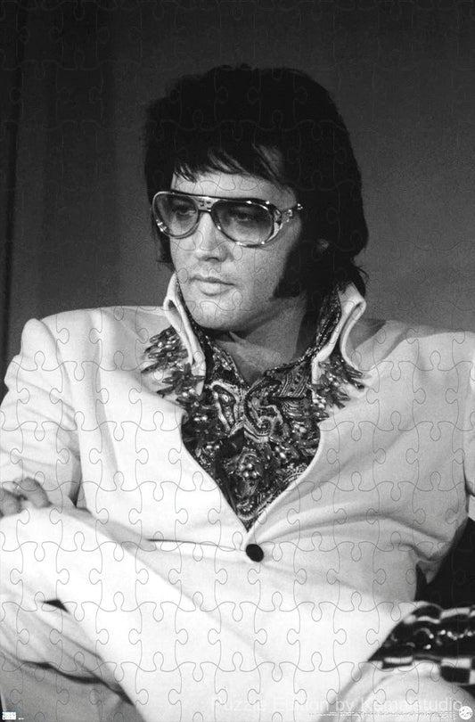 Elvis in a quiet moment, resting with his guitar in classic sepia tone